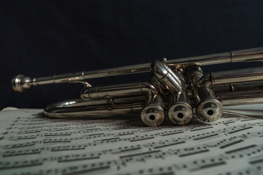 silver trumpet on white paper