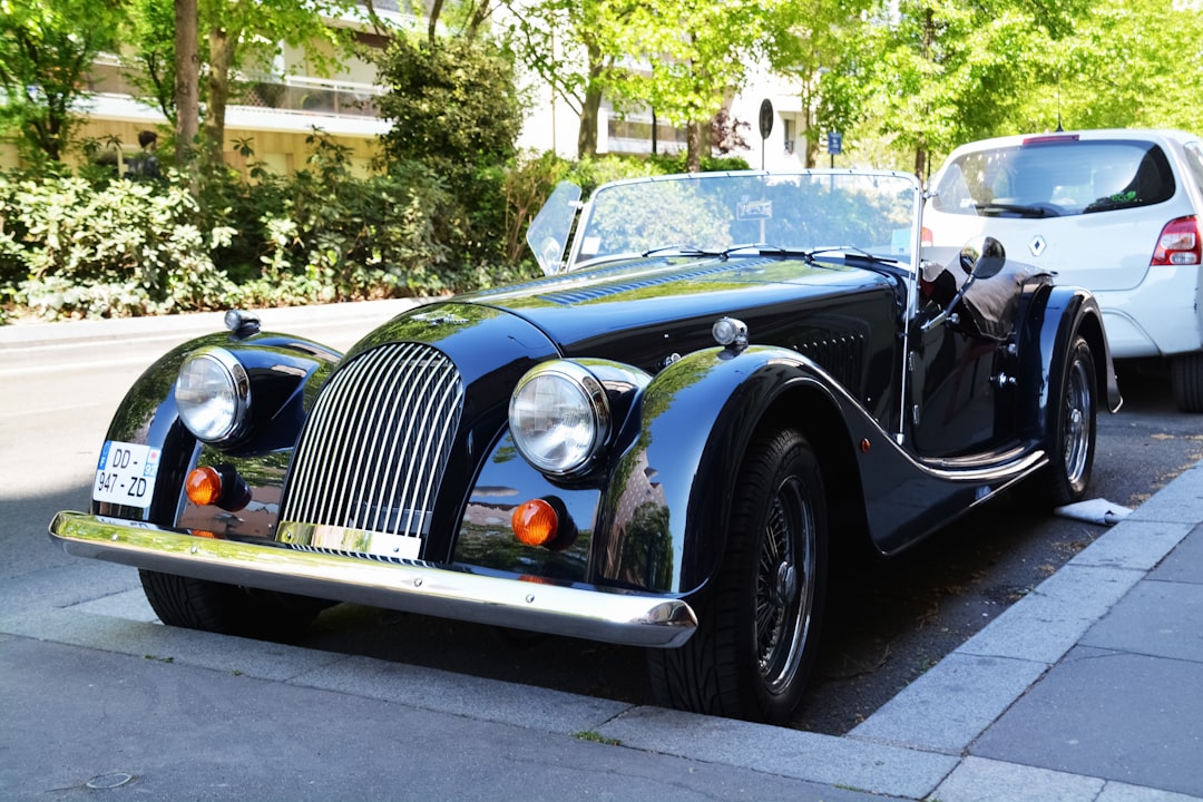 black classic car parked on sidewalk during daytime