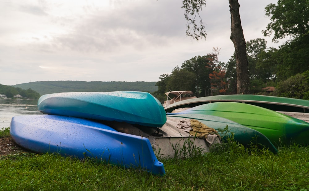 blue and green boats on green grass field during daytime