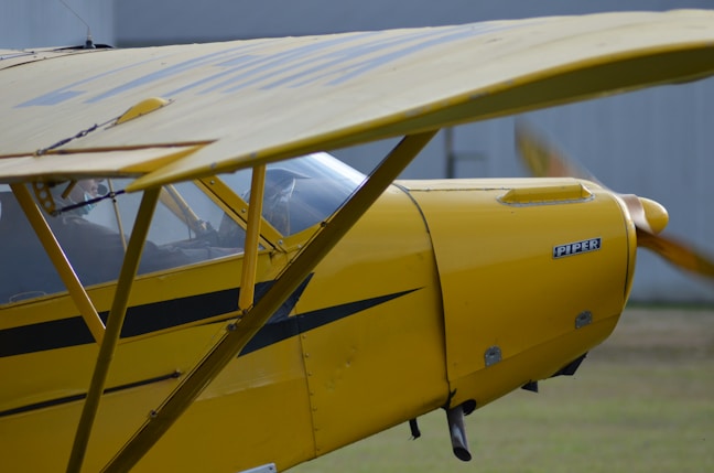 yellow and black plane on white sand during daytime