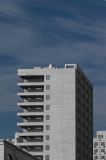 white and black concrete building under blue sky during daytime