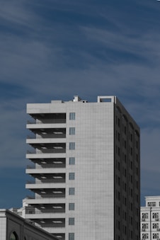 white and black concrete building under blue sky during daytime