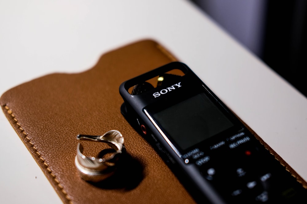 black panasonic wireless phone on brown wooden table