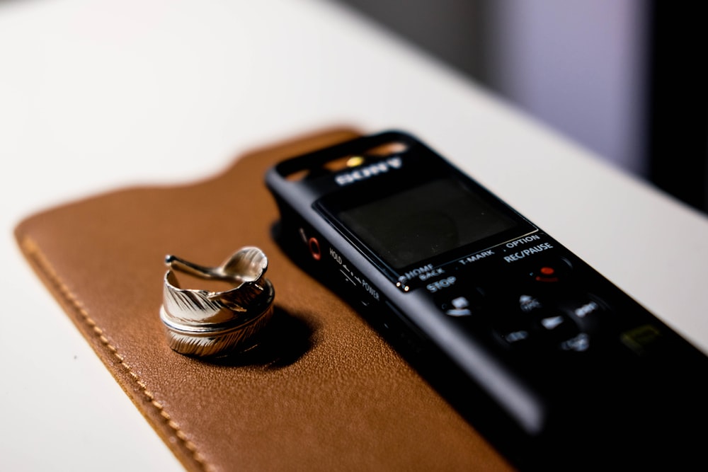 black sony digital device on brown wooden table