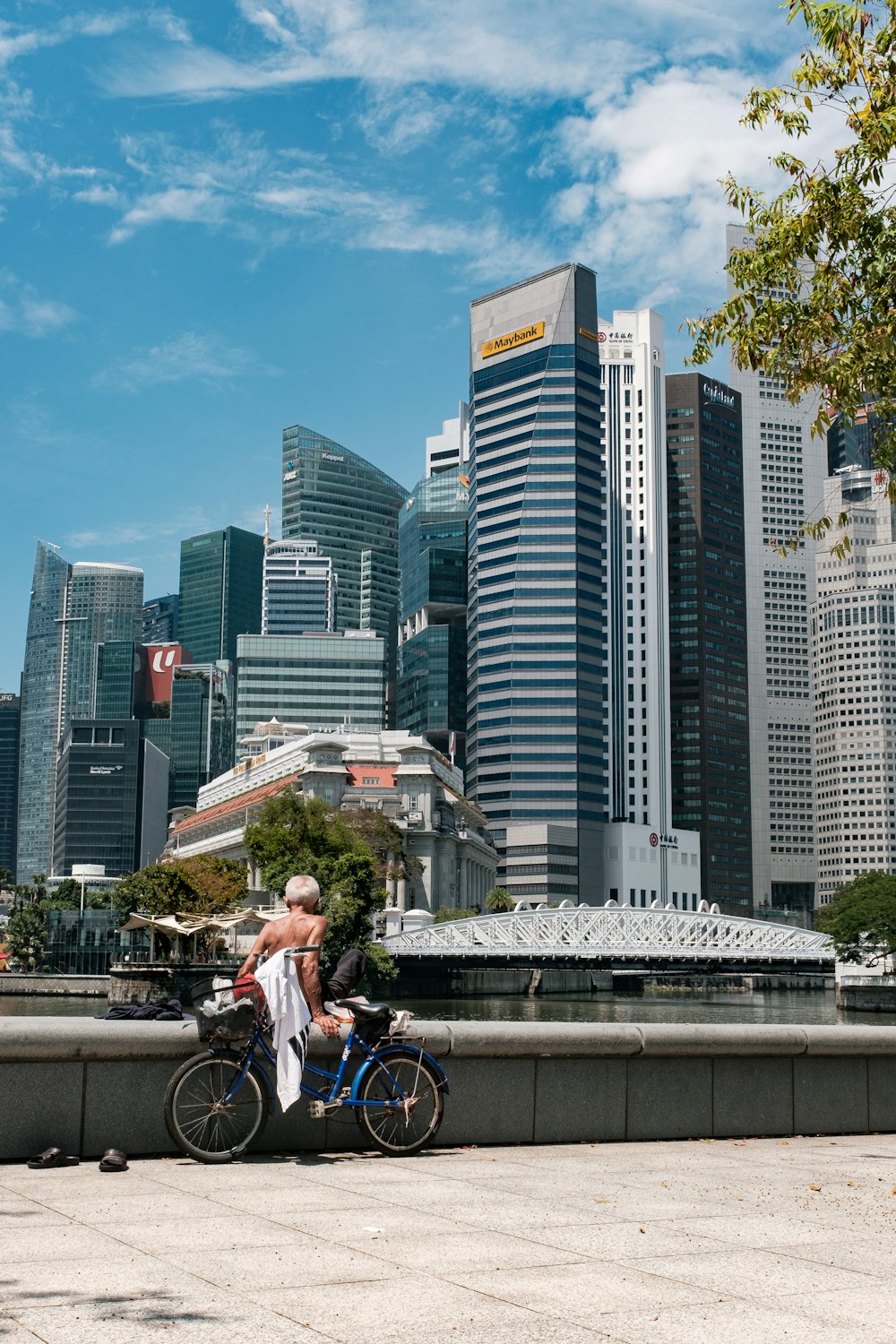 man in white shirt riding bicycle on road during daytime