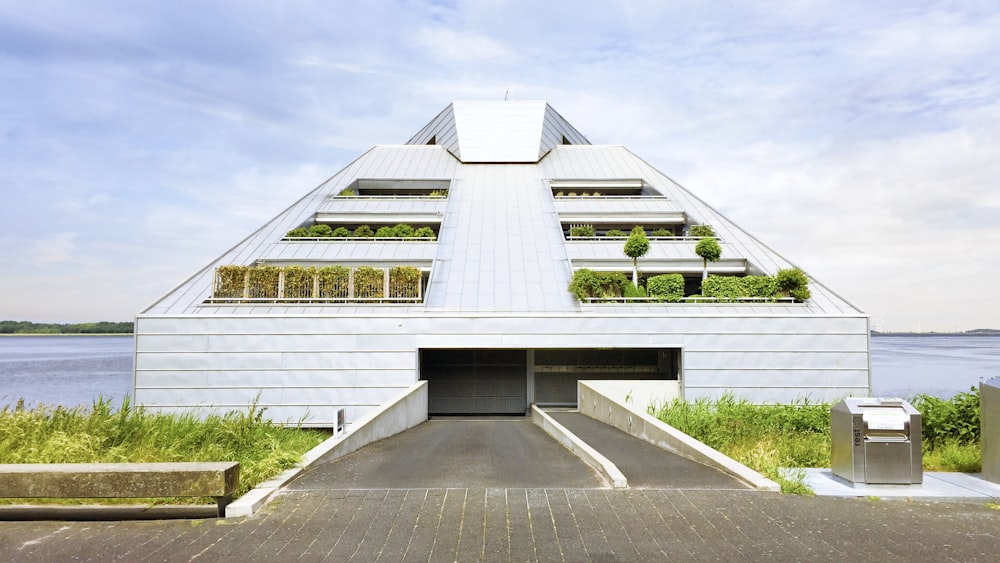 white concrete building under white clouds during daytime