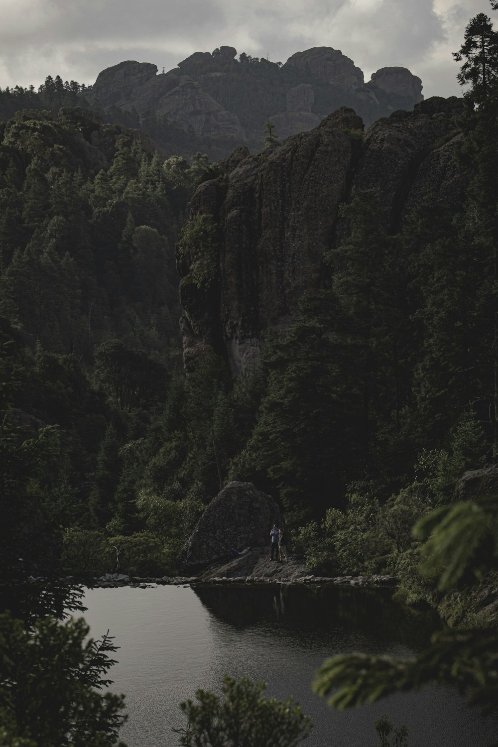 body of water near mountain during daytime