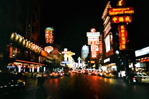A vibrant neon sign glowing in a city street at night.