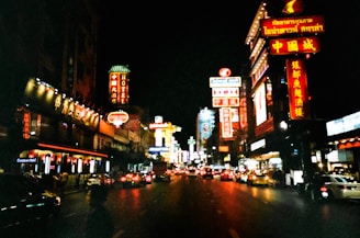 A vibrant neon sign glowing in a city street at night.