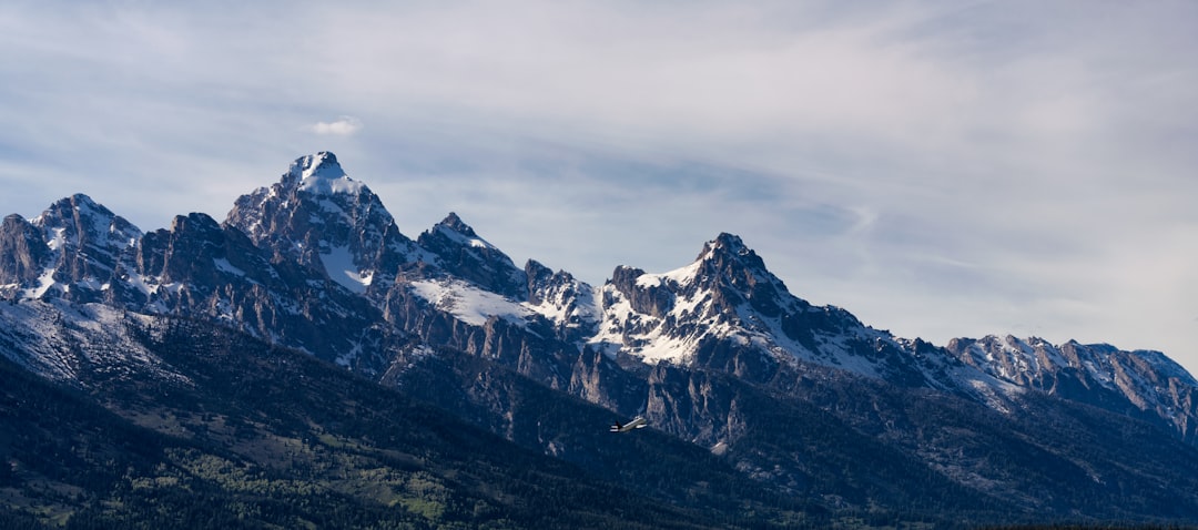 snow covered mountain under cloudy sky during daytime