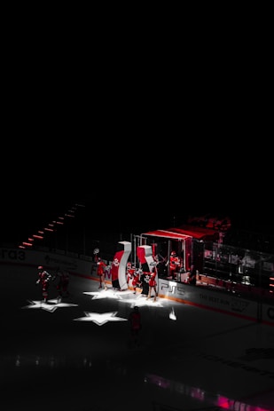 people riding on red and white ship during night time