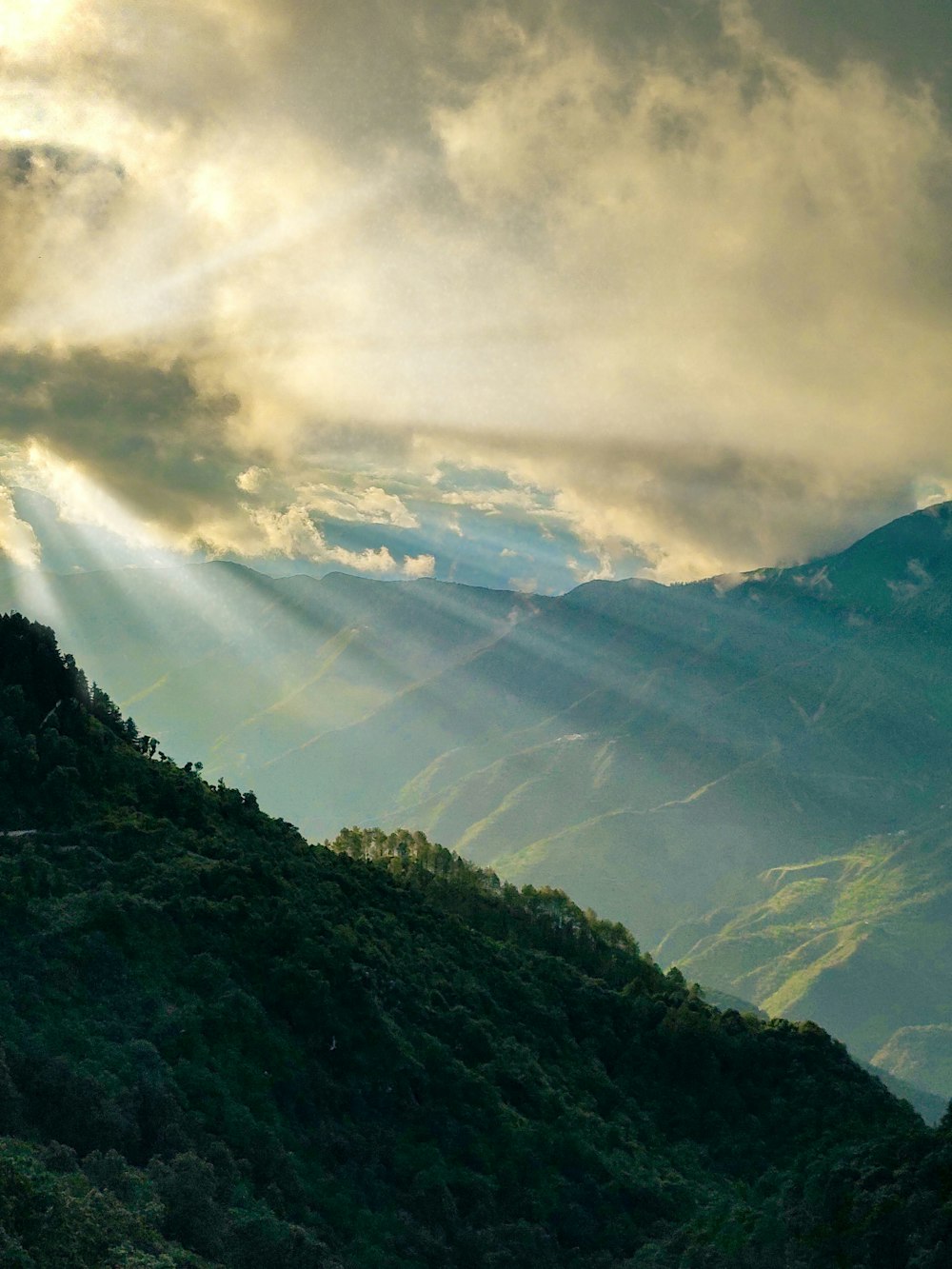 green mountains under white clouds during daytime