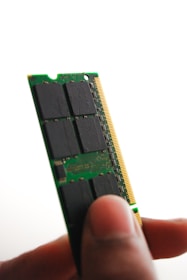 Close-up of a technician installing RAM in a desktop computer.