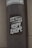 A weathered pole displays a monochromatic sticker with bold, stylized text reading 'The Kulture of Hype & Hope'. The surrounding environment suggests an urban setting with a gritty texture.