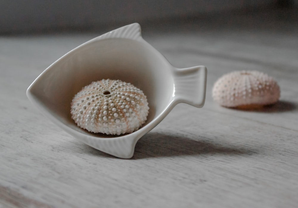 white ceramic teacup on white table