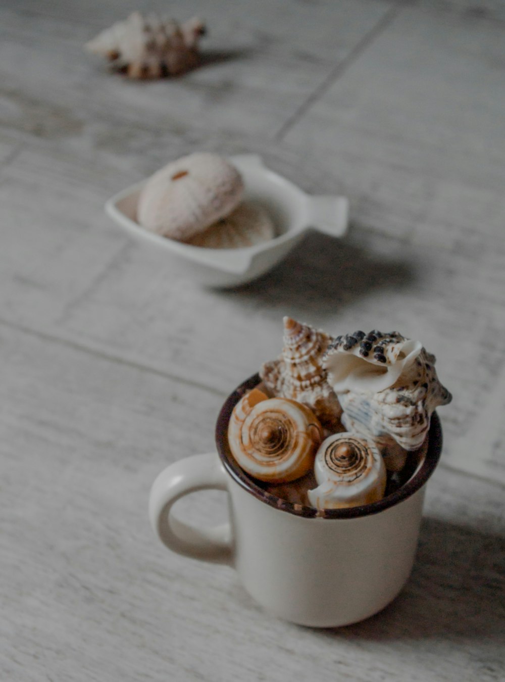 white ceramic mug with two cupcakes