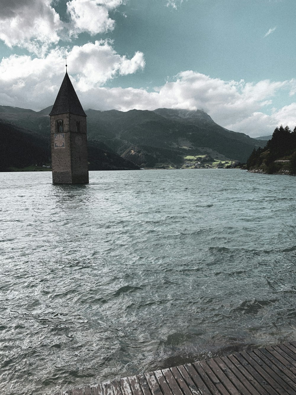 brown concrete tower on body of water during daytime