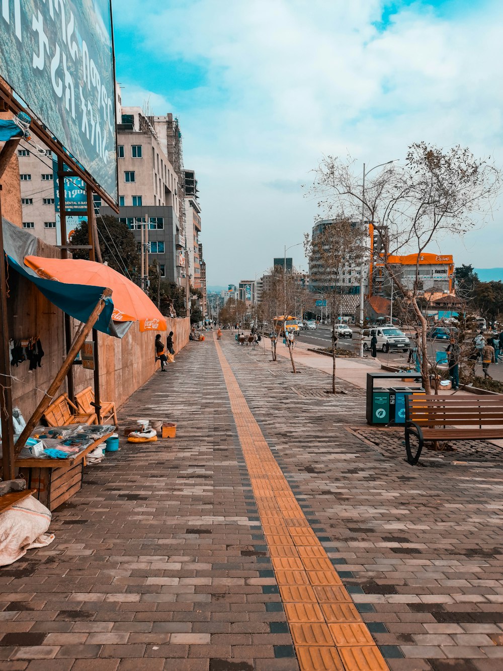 people walking on sidewalk near buildings during daytime