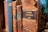 A collection of old, leather-bound books with various titles visible on their spines. The books appear worn and aged, indicating they have been used frequently or are quite old. The focus is on one particular book labeled 'Memorial Administratif 1881,' suggesting a historical or administrative context.