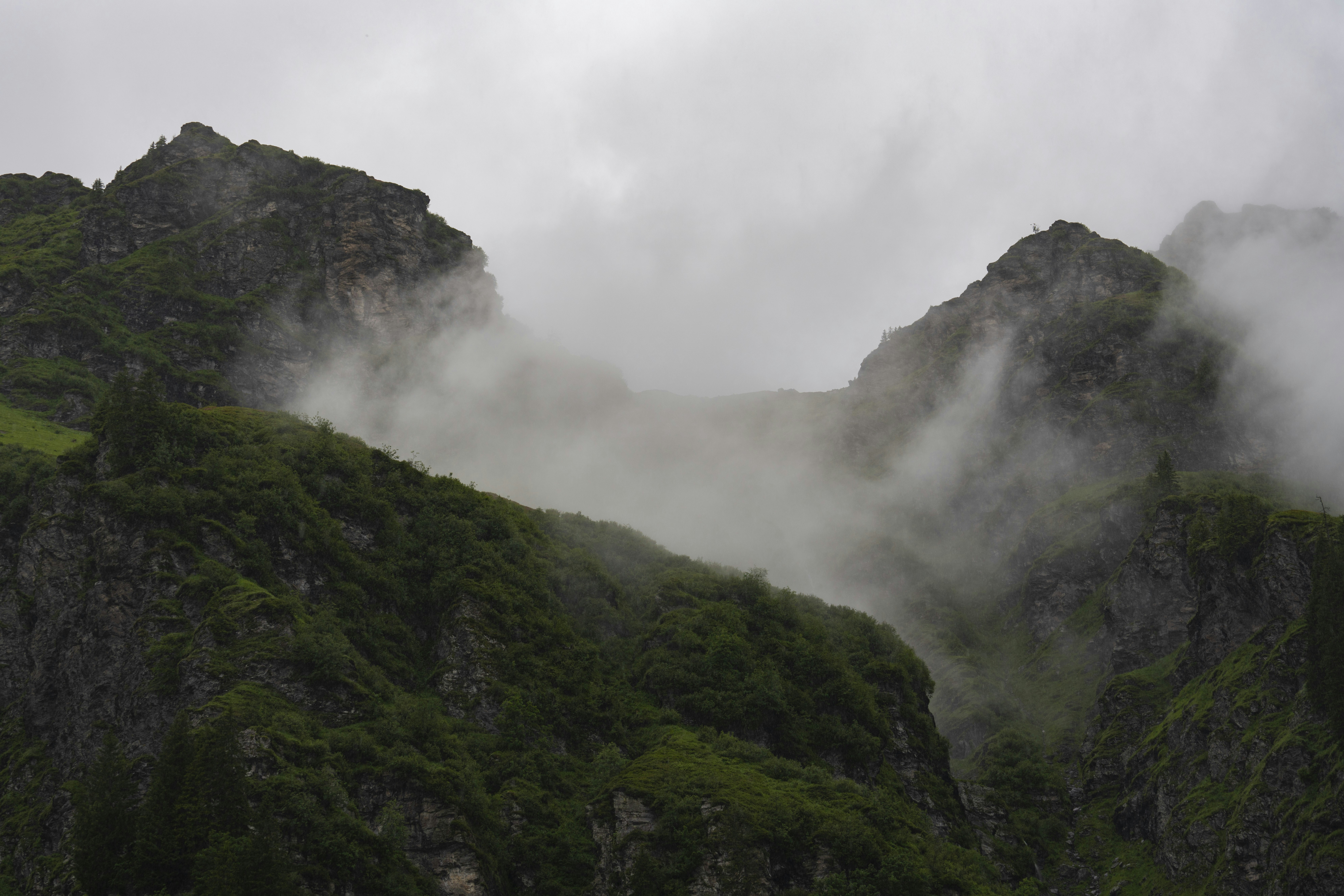 green mountain under white clouds during daytime