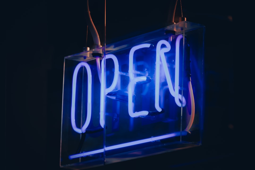 blue and white open neon light signage