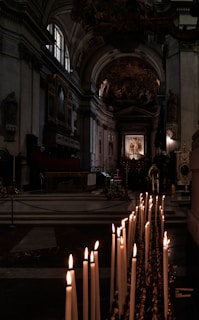 A serene view of the ancient altar inside the Anba Shenouda Church, bathed in soft candlelight.
