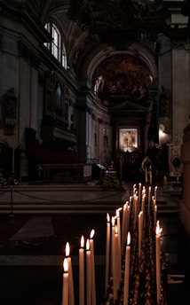 A serene view of the ancient altar inside the Anba Shenouda Church, bathed in soft candlelight.