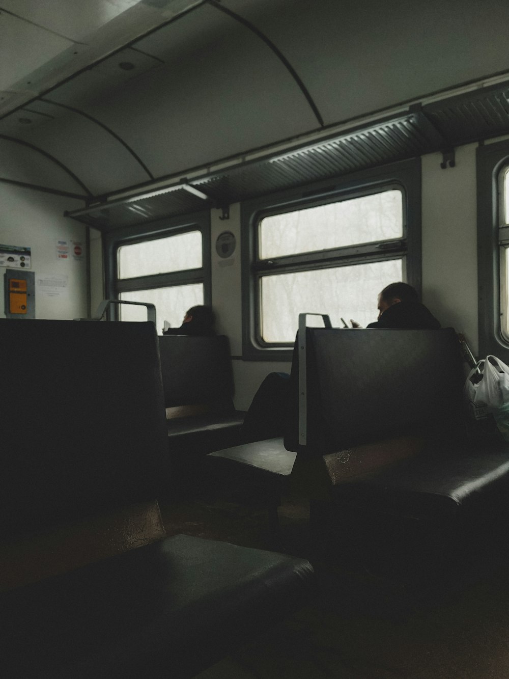 man in black jacket sitting on black chair