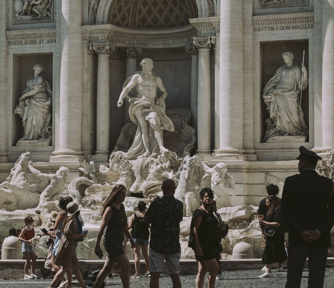 people standing in front of white concrete statue