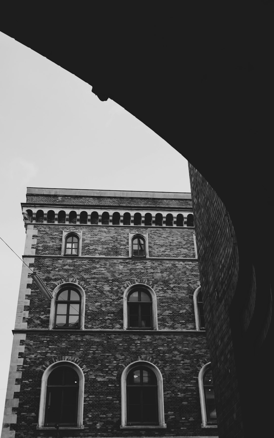 grayscale photo of brick building