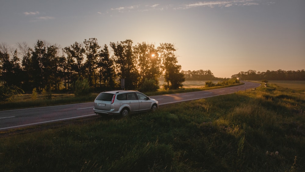 silver sedan on road during daytime