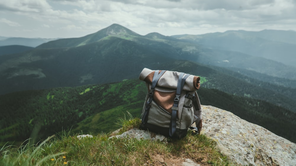 black and gray hiking backpack on green grass field during daytime