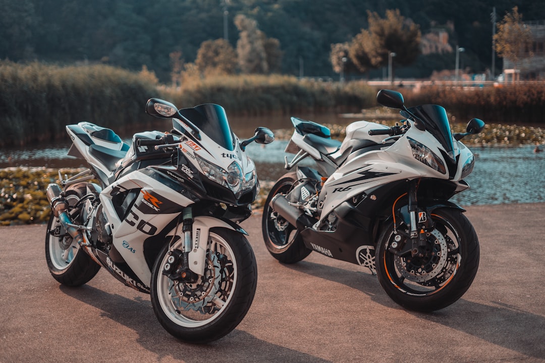 white and black sports bike on brown dirt road during daytime