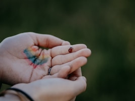 persons hand with blue and green color