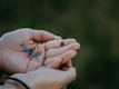 persons hand with blue and green color