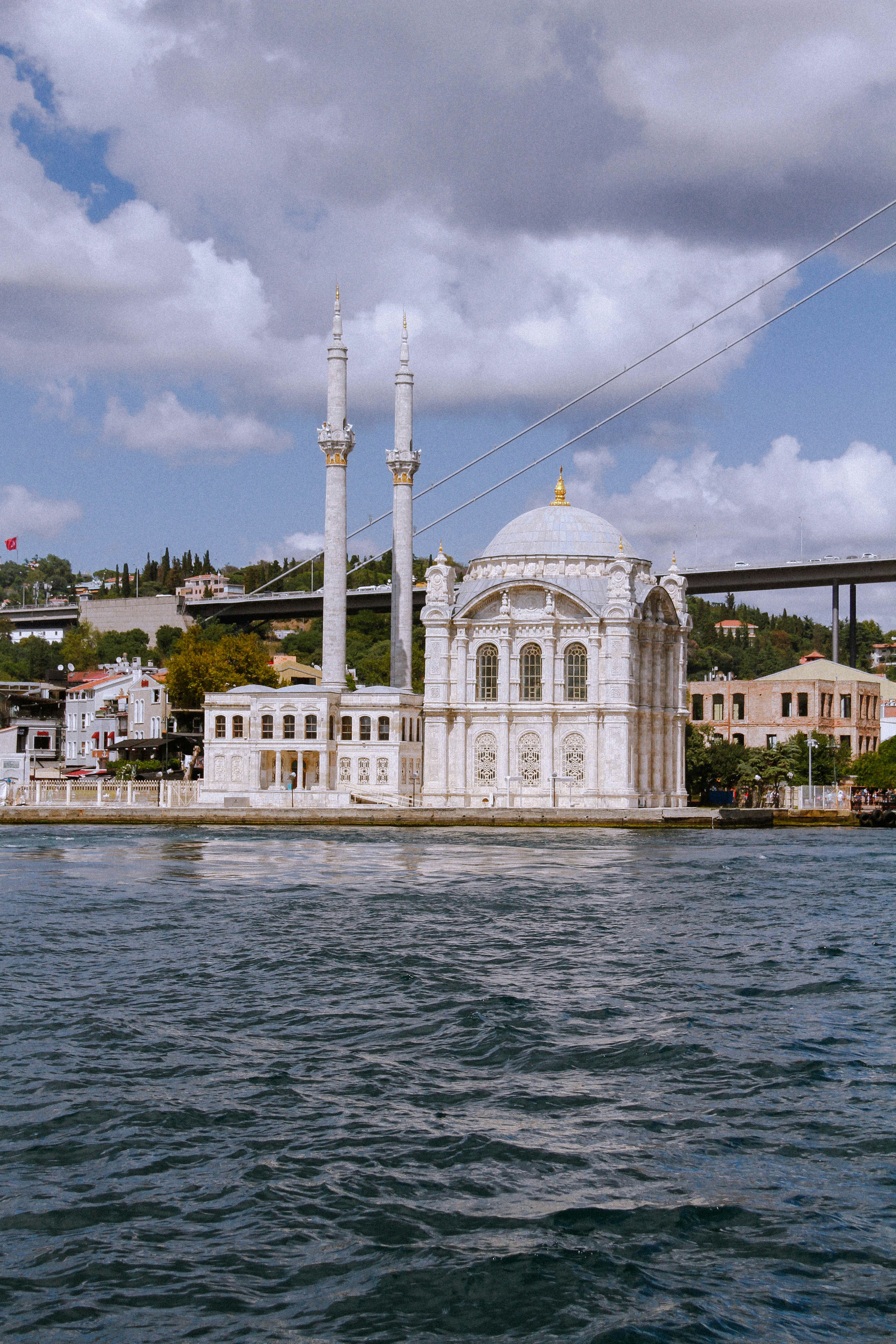 white and brown concrete building near body of water during daytime