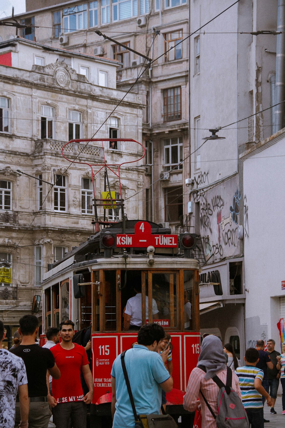 people walking on street near white concrete building during daytime