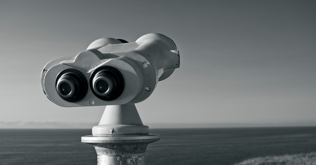 gray binoculars on green textile