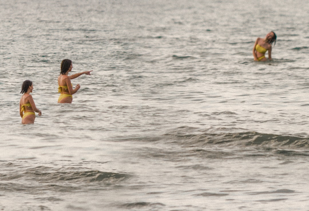 man in blue shorts on body of water during daytime