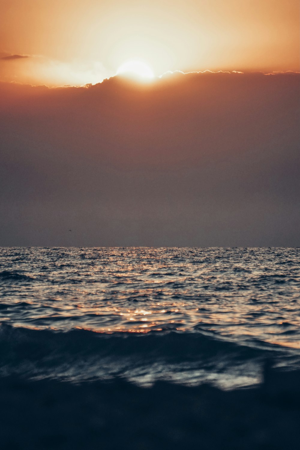 ocean waves under gray sky during daytime