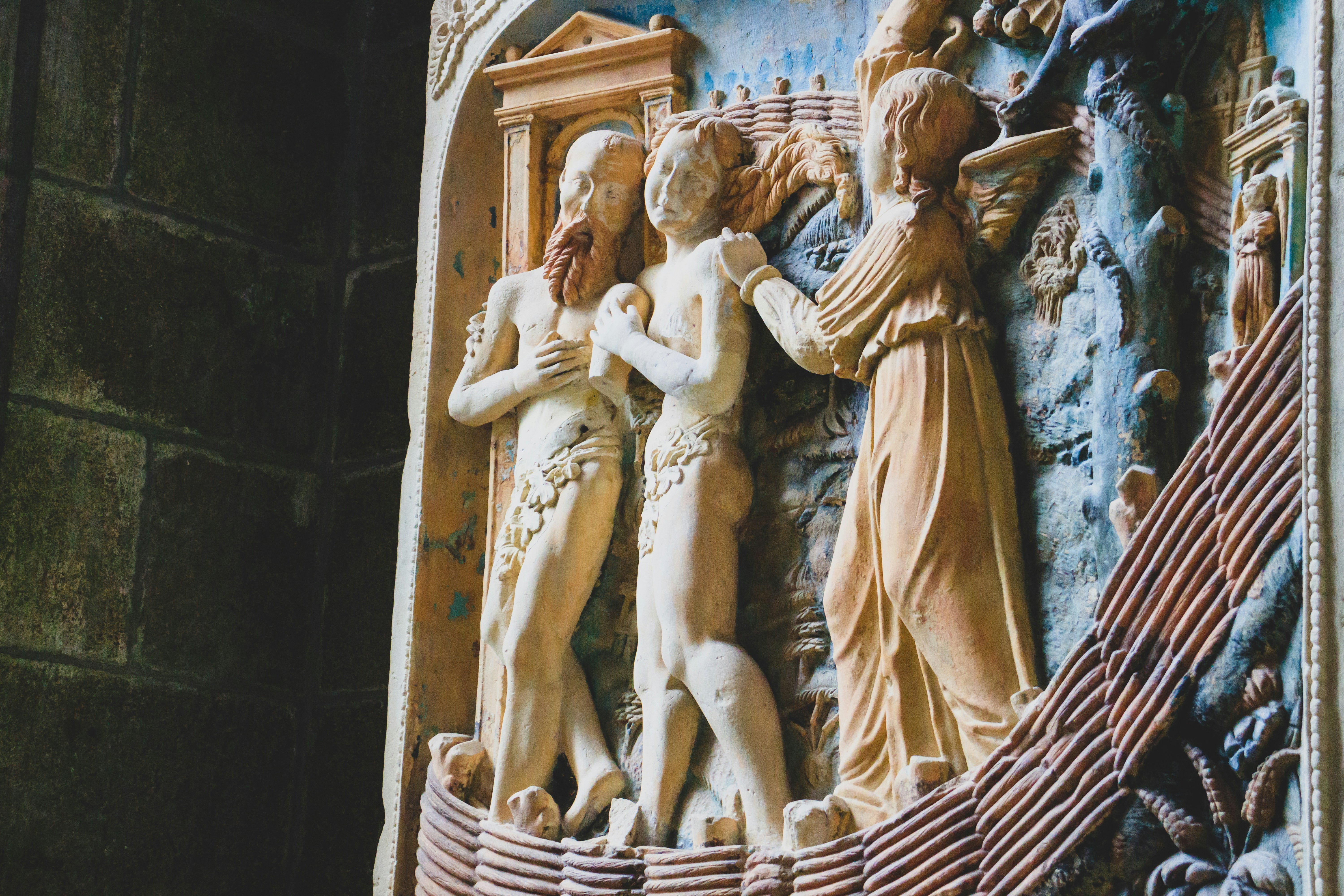 man and woman statue on brown wooden table