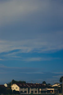 A neat row of residential buildings under clear blue skies, symbolizing managed properties.