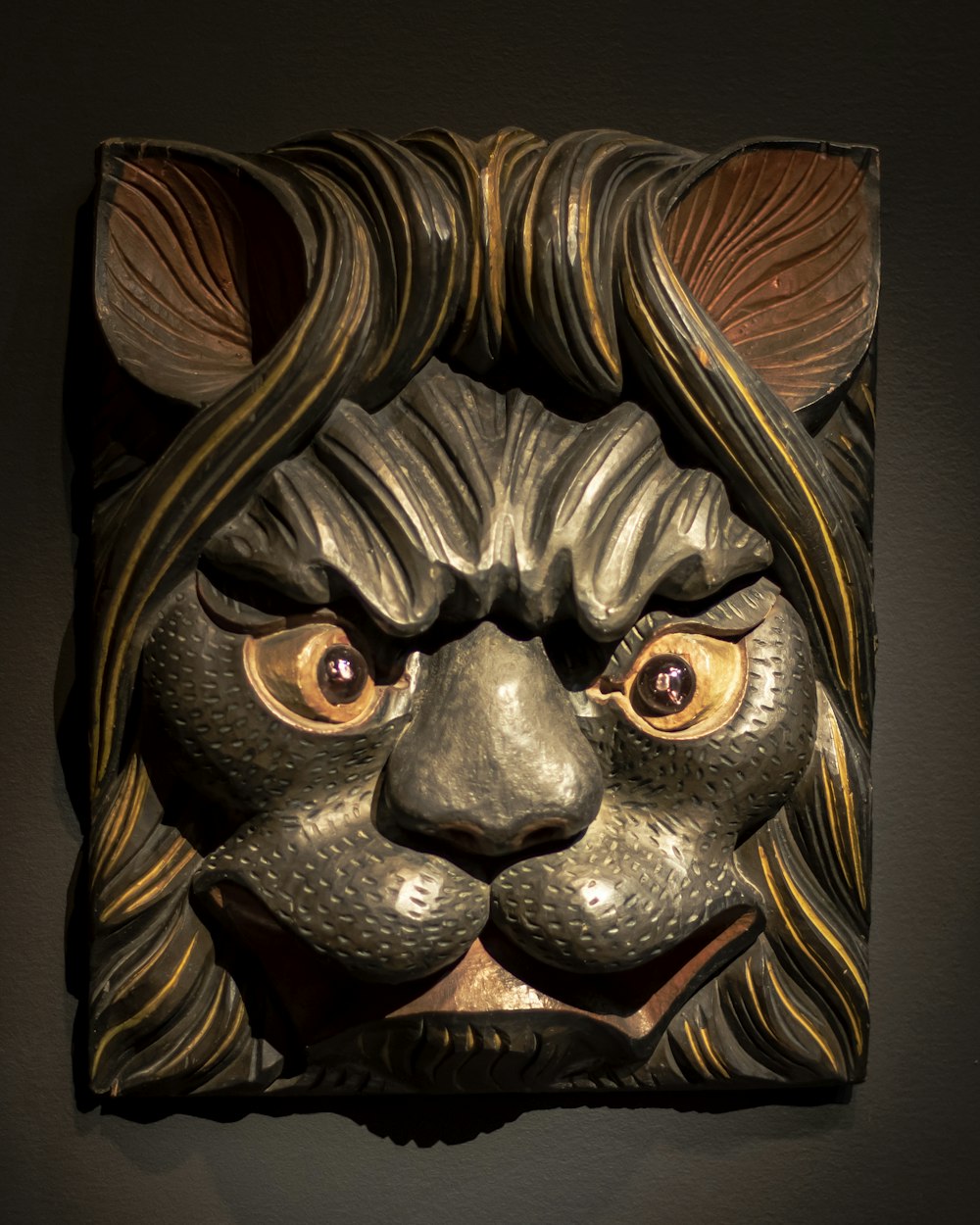 gold and black lion head bust