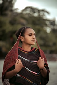 woman in red scarf and black and white striped shirt