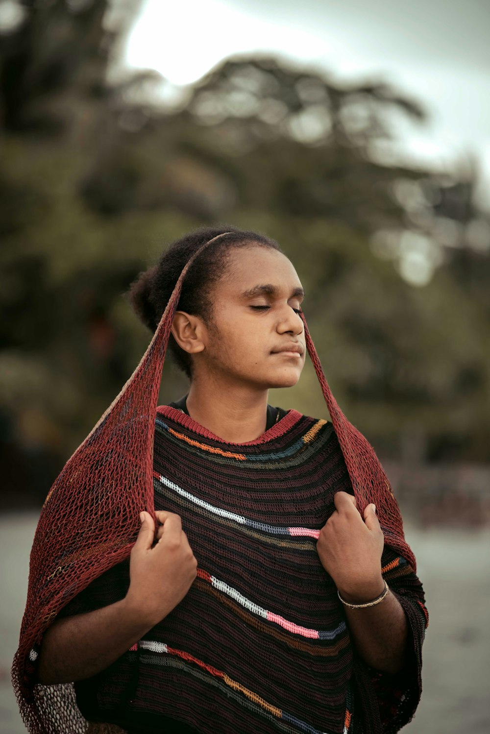 woman in red scarf and black and white striped shirt