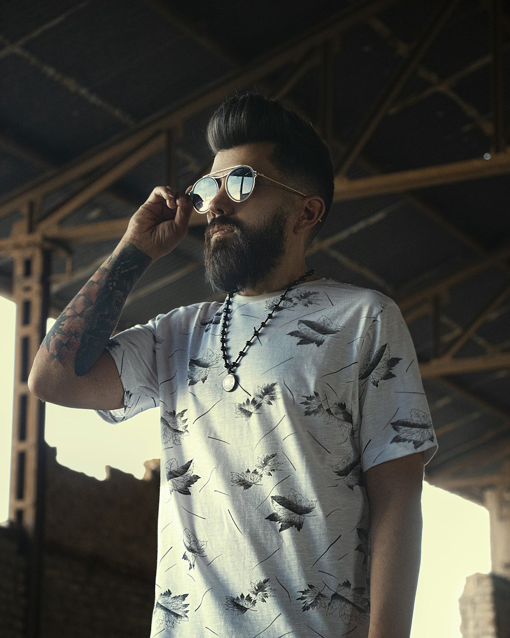 man in white and black crew neck t-shirt wearing black sunglasses