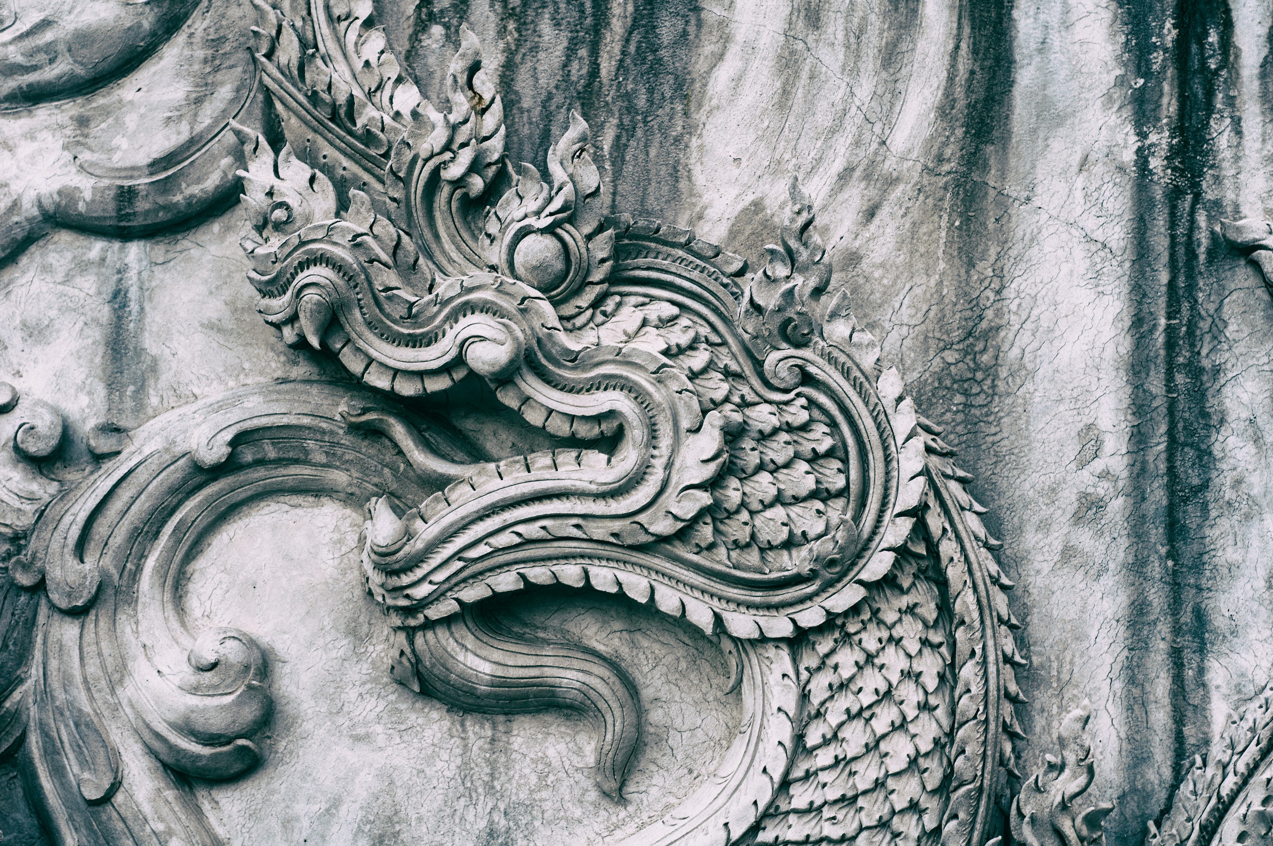 gray concrete wall with dragon embossed