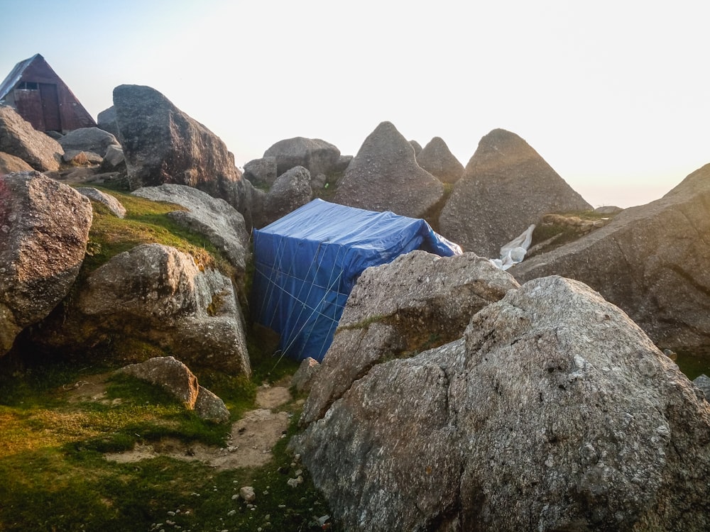 blue textile on gray rock formation during daytime