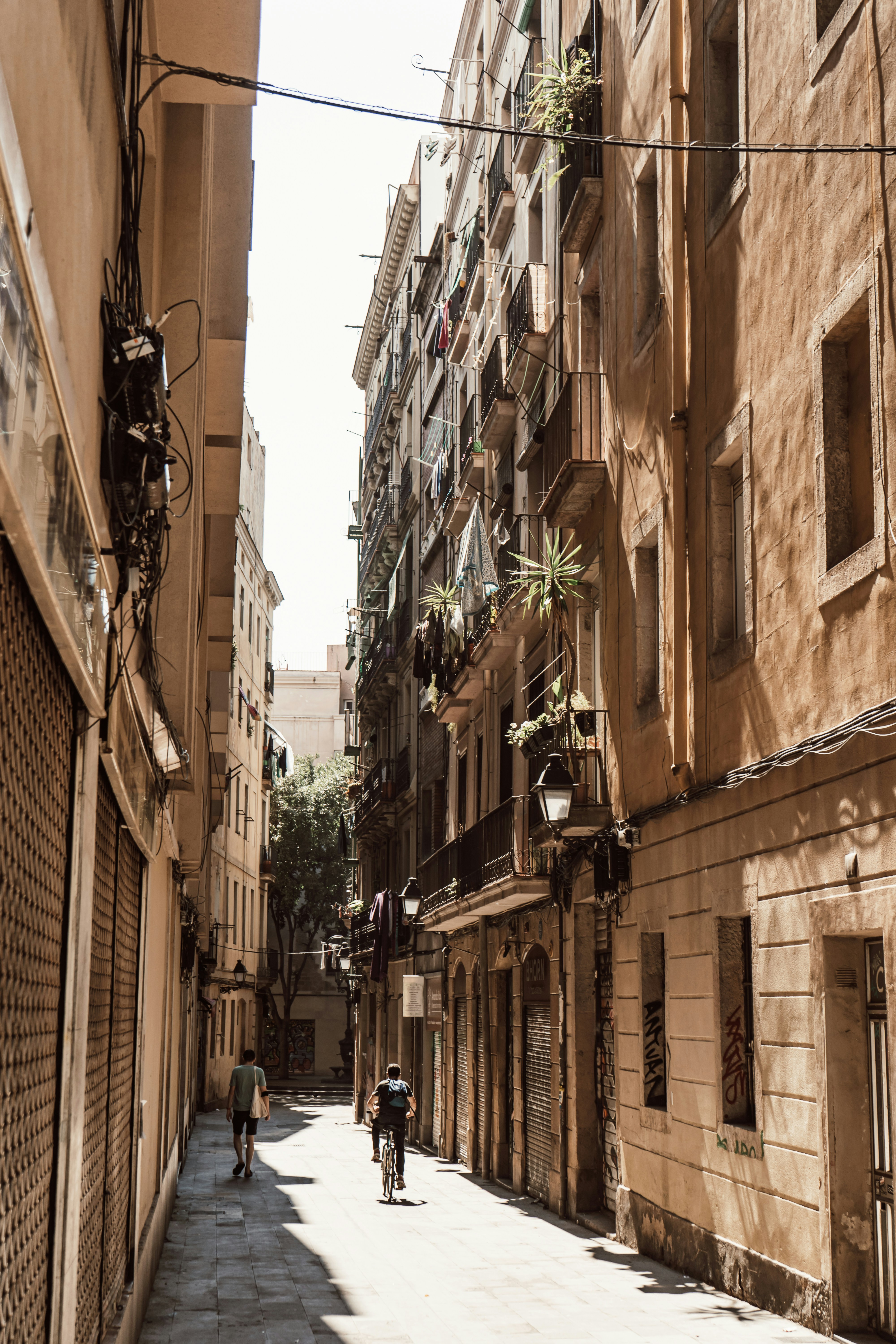 people walking on street between buildings during daytime