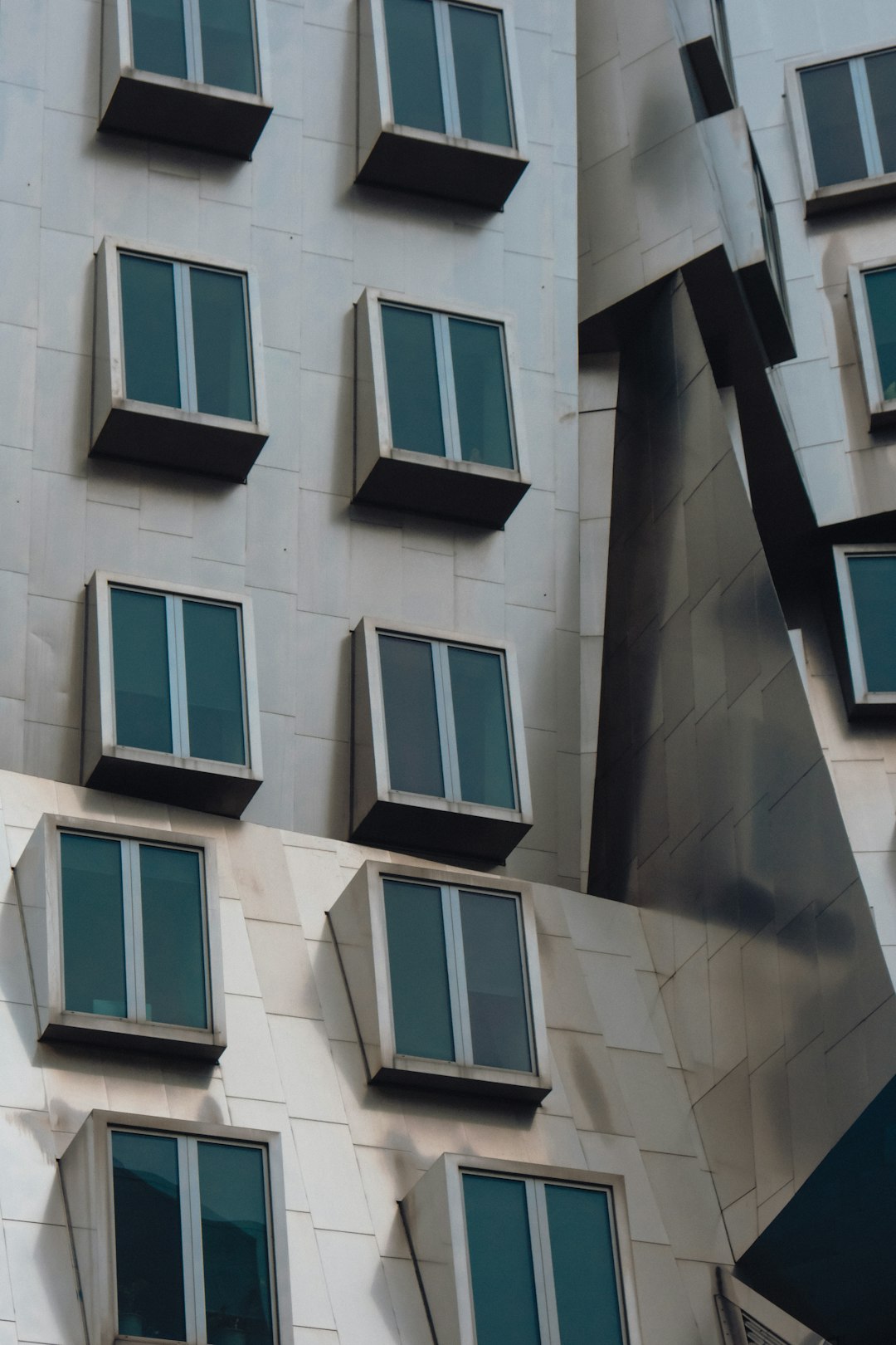 white concrete building with blue windows